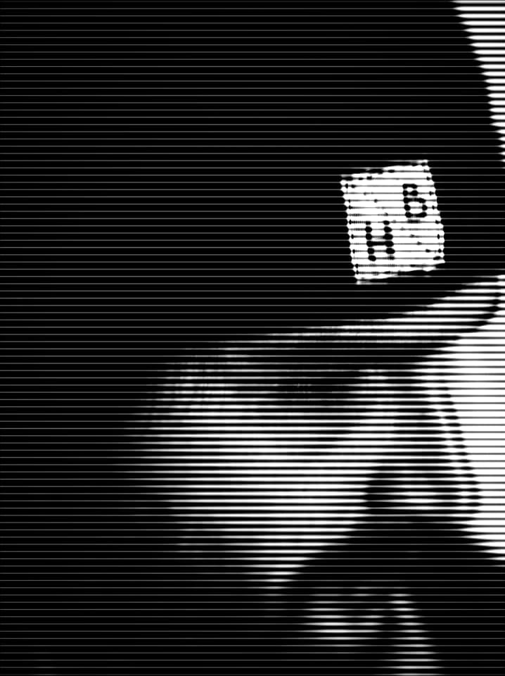 High-contrast portrait of Hanif Bahari wearing a black beanie in profile